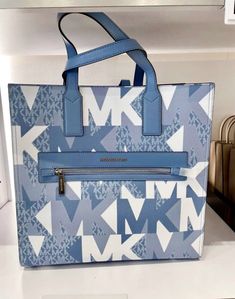 Michael Kors Kenly Large NS Tote Crossbody Graphic Logo MK Blue White Multi. Michael Kors Kenly Large NS Tote Kenly Large Graphic Logo Tote Bag your daily tote bag. Made from coated canvas with a graphic take on our logo initials, this structured carryall features sleek top handles and a front zip pocket that will keep your essentials within arm’s reach • Tote bag • Logo-print canvas • Silver-tone hardware • 14.25”W X 14”H X 5.5”D • Adjustable strap: 16”-25” • Exterior details: front zip pocket • Interior details: back zip pocket, 2 back slip pockets Price is firm Luxury Multicolor Formal Leather Shoes, Luxury Workwear Boots, Luxury Boots For Workwear, Luxury Blue Formal Boots, Blue Coated Canvas Bags For Errands, Blue Coated Canvas Bag For Errands, Blue Coated Canvas Shoulder Bag, Blue Michael Kors Tote Shoulder Bag, Blue Coated Canvas Shoulder Bag For Errands