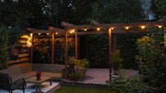 an outdoor seating area is lit up with string lights