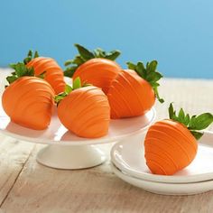 four pieces of chocolate covered strawberries on a white plate