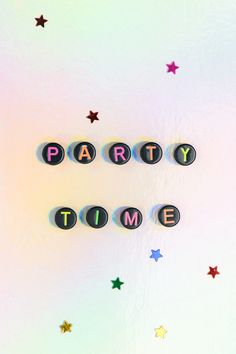 the word party time spelled out with magnets on a white background surrounded by stars