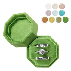 an open ring box with three rings in it and four different colors on the inside