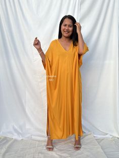 Celebrate your curves with our plus size kaftan dress. Created to embrace all body types, this kaftan is designed with care and style in mind. Its loose, flowing silhouette complements your figure while offering unbeatable comfort. The perfect choice for a night on the town or lounging at home. Oversized V-neck Tunic For Beach Cover-up, Rayon Maxi Length Kaftan, Rayon V-neck Kaftan For Beach Cover-up, V-neck Rayon Kaftan For Beach Cover-up, Oversized Long Beachwear Dress, Oversized Yellow Maxi Dress For Summer, V-neck Kaftan For Loungewear, Free Size V-neck Kaftan For Loungewear, V-neck Maxi Dress For Loungewear In One Size