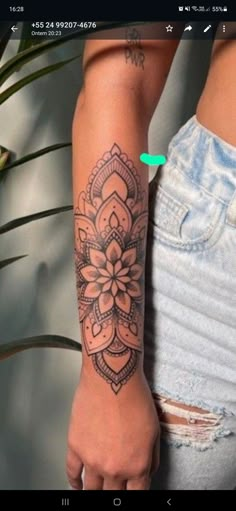 a woman's arm with a tattoo on it and a flower in the middle