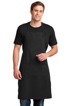 a man wearing an apron and smiling at the camera with his hands in his pockets