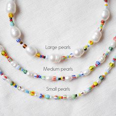 Freshwater pearl necklace with striped beads is colorful and cute. In this beaded necklace, I have paired white genuine freshwater pearls with colorful glass seed beads. Lovely piece that adds color to any outfit!  14k gold plated / stainless steel, or silver-plated / stainless steel. Choose from 3 irregular shape pearl sizes:  - Large (8-10 mm) - Medium (5-6 mm) - Small (3-4 mm) Choose the length of your necklace:  - 15 inches with extension - can be adjusted between 15 inches and 17 inches (38 - 43 cm) - 17 inches with extension - can be adjusted between 15 inches and 17 inches (43 - 48 cm) Please send me a message if you want another size 😊 Looking for a matching bracelet? You can find it here: https://www.etsy.com/listing/1529726355 See my whole jewelry collection: https://www.etsy.co Summer White Beaded Necklaces With Spacer Beads, Summer Necklace With Colorful Beads On White, Summer Necklace With Colorful Beads In White, White Spacer Beads Jewelry For Summer, Summer Pearl White Necklaces With Round Beads, Multicolor Tiny Beads Pearl Necklace, White Letter Beads Necklace For Summer, White Beaded Necklace For Summer Gifts, Summer White Necklaces With Letter Beads