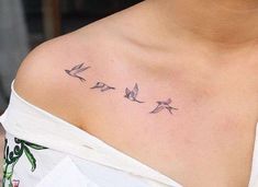 a woman's chest with three birds on it