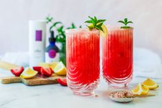 two glasses filled with watermelon lemonade and garnish