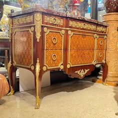 an ornately decorated wooden dresser in a store