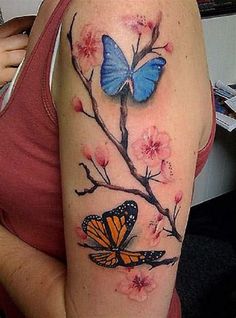 a woman's arm with a butterfly and flower tattoo on the left side of her arm