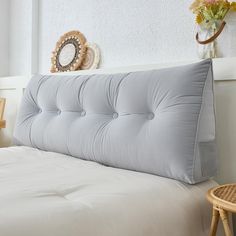 a close up of a bed with a pillow on it