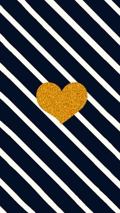 a gold heart on a black and white striped background