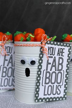 three buckets with fake carrots in them decorated to look like faces and eyes