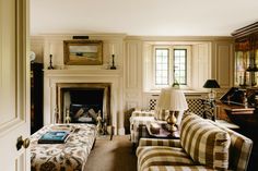 a living room filled with furniture and a fire place