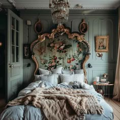 a bedroom with a large bed covered in blankets and pillows