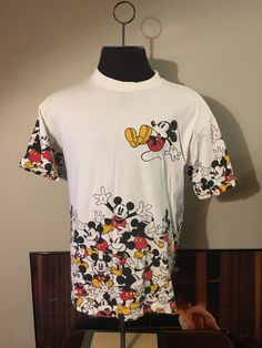 a white shirt with mickey mouse on it