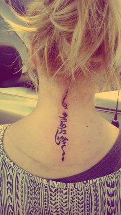 a woman with a tattoo on her neck that says, i love you in arabic