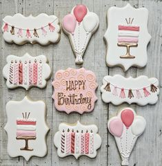 decorated cookies with happy birthday written on them and balloons in the shape of cake slices