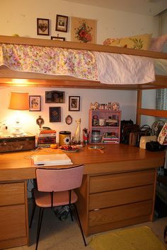 a bedroom with bunk beds, desk and chair