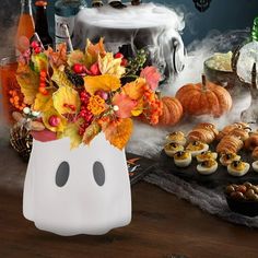 a table topped with cupcakes and halloween decorations