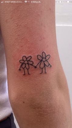 a tattoo on the arm of a woman with two flowers in each side of her arm