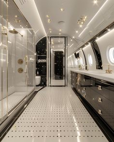 an airplane bathroom with black and white tile on the floor, gold trimmings