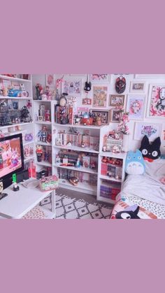 a room filled with lots of toys and bookshelves on the wall next to a bed