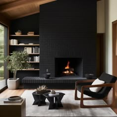 a living room filled with furniture and a fire place next to a large glass window