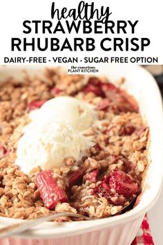 strawberry rhubarb crisp in a white dish with ice cream on top