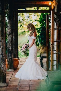 a woman in a wedding dress holding a bouquet