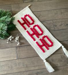 a crocheted sign with the words'hold on'written in red and white yarn