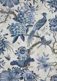 a blue and white floral wallpaper with birds on branches, flowers, and leaves