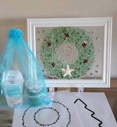 a table with some items on it including a wreath and hand sanitizing gels