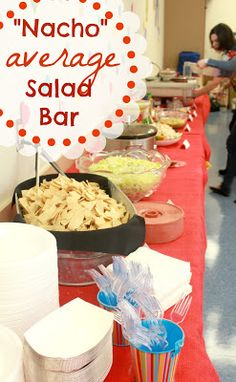 a long table with food on it and a sign that says nacho average salad bar