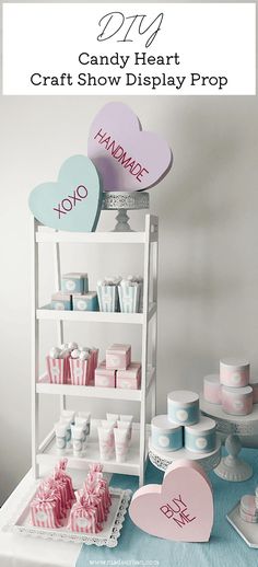 candy heart craft show display prop with pink and blue hearts on it, surrounded by other items