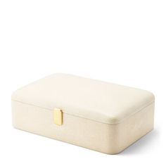 a white box with a gold handle on the top and bottom, sitting in front of a white background