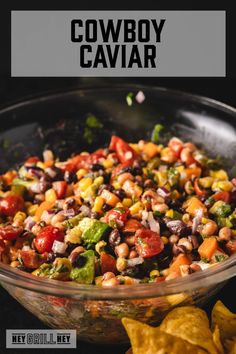 a bowl filled with black beans, corn and salsa next to tortilla chips