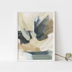 an abstract painting on a white wall next to a plant