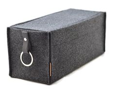 a black case with a key ring hanging from it's front end, on a white background