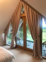 a bedroom with a large bed and sliding glass doors leading to a balcony area that overlooks the golf course