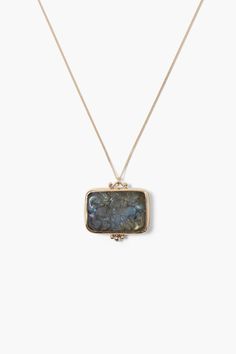 A luminous hand carved labradorite flower pendant with a diamond inlay strung on a solid 14k gold chain.14k yellow gold, labradorite, .03ct white diamond.17" - 19" adjustable.Handmade in Vietnam.