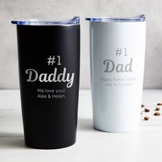 two personalized tumblers sitting on top of a white table next to each other