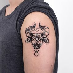 a man with a bull tattoo on his arm