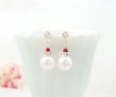 "These crystal drop earrings are made with 8mm Swarovski® White pearls, clear crystal rondelles and tiny 3mm ruby red crystals, which dangle from crystal silver stud earrings. These small 3/4\" long sparkly silver wedding earrings make a lovely bridesmaid or bridal party gift. If you would like these earrings made with a different color crystal and/or pearl, just message us. Thank you for looking. - Shop Gemsicles, an Etsy boutique with hundreds of sparkly items for weddings, gifts and just beca Red Pearl Drop Earrings For Wedding, Red Pearl Earrings For Wedding, Red Pearl Drop Bridal Earrings Gift, Bridal Proposal, Weddings Gifts, Etsy Boutique, Ivory Pearl, Crystal Drop Earrings, Bridal Party Gifts