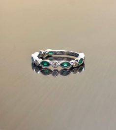 DeKara Designs Collection Metal- 18K White Gold, .750. Stones- 7 Genuine Marquise Colombian Emeralds 0.45 Carats, 6 Round Diamonds F-G Color VS2 Clarity 0.15 Carats. Size- 4-12 Beautifully Handmade 18K White Gold Diamond Colombian Emerald Engagement Band. All the emeralds are a high quality, with a beautiful rich green and marquise in shape. You get the most brilliance from these emeralds do to a superior color and because of it's origin. The emeralds are a beautiful green and are matched by col Emerald Eternity Band, Sapphire Band, Engagement Band, Colombian Emeralds, Emerald Engagement, Rich Green, Engagement Bands, Art Deco Diamond, Diamond Wedding Band