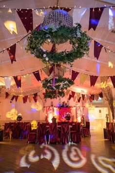 an image of a banquet hall setting with decorations on the ceiling and lights in the background