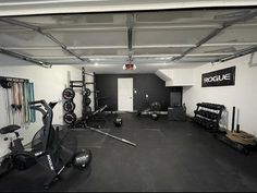 an empty gym room with exercise equipment on the floor