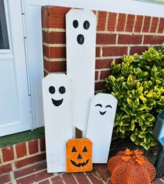 a couple of pumpkins sitting in front of a house