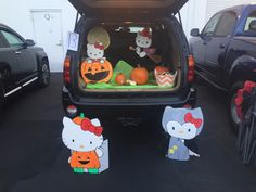 hello kitty pumpkins are in the back of a car with hello kitty cutouts