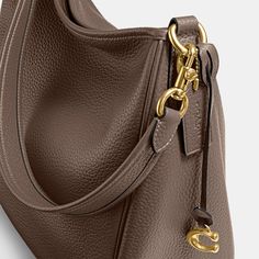 Deliberately slouchy with a sophisticated ease our Cary is a study in intentional laidback style. Crafted of buttery soft pebble leather with a silky sheen this surprisingly spacious bag has plenty of pockets to keep you organized. (Because even your most easygoing self should feel put-together.) | Coach Cary Shoulder Bag - Women's Purses - Brass/dark Stone