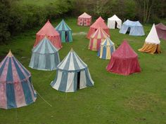 many tents are set up in the grass